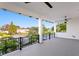 Expansive covered balcony with ceiling fans offering scenic waterfront views of the surrounding neighborhood at 5004 S The Riviera, Tampa, FL 33609