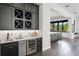 Stylish bar area with a wine fridge, built-in cabinets, and a view of the kitchen at 5004 S The Riviera, Tampa, FL 33609