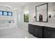 This bathroom offers a soaking tub and modern vanity, perfect for a modern aesthetic at 5004 S The Riviera, Tampa, FL 33609