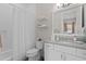 Cozy bathroom featuring a shower-tub, a toilet, a vanity and stylish decor at 5004 S The Riviera, Tampa, FL 33609