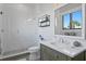 Modern bathroom with glass enclosed shower, gray vanity and a window with a view at 5004 S The Riviera, Tampa, FL 33609