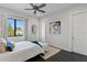 Bright bedroom featuring a ceiling fan, modern art and large window with neighborhood views at 5004 S The Riviera, Tampa, FL 33609