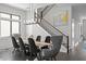Elegant dining room with a long table, modern chandelier, and a view of the staircase at 5004 S The Riviera, Tampa, FL 33609