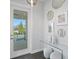 Elegant entryway with glass table, mirrored wall decor, and a view of the exterior patio at 5004 S The Riviera, Tampa, FL 33609