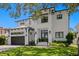 Stunning two-story home featuring a modern design, lush landscaping, and a spacious two-car garage at 5004 S The Riviera, Tampa, FL 33609