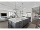 Modern kitchen with a large island, stainless steel appliances, and open to the living area at 5004 S The Riviera, Tampa, FL 33609