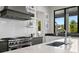 Modern kitchen with granite countertops, sleek white cabinetry, stainless steel appliances and eat-in counter seating at 5004 S The Riviera, Tampa, FL 33609