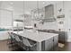 An impressive kitchen features an oversized island with seating, stylish lighting, and modern appliances at 5004 S The Riviera, Tampa, FL 33609