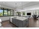 An airy kitchen overlooks an open living area, blending cooking and Gathering spaces seamlessly with lots of natural light at 5004 S The Riviera, Tampa, FL 33609