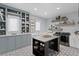 A spacious laundry room with built-in storage, modern appliances, and an island for folding at 5004 S The Riviera, Tampa, FL 33609