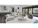 Open-concept living room with sleek furniture, hardwood floors, and access to the outdoor patio at 5004 S The Riviera, Tampa, FL 33609