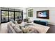 Comfortable living area with a plush sofa, chic decor, and expansive windows overlooking the outdoor patio at 5004 S The Riviera, Tampa, FL 33609