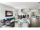 Spacious living room with comfortable seating, large TV, and a view of the staircase at 5004 S The Riviera, Tampa, FL 33609