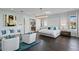 This main bedroom offers a sitting area and en suite with elegant decor and hardwood floors at 5004 S The Riviera, Tampa, FL 33609