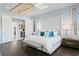 This main bedroom offers a king bed and en suite with elegant decor and hardwood floors at 5004 S The Riviera, Tampa, FL 33609