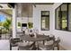 Covered patio with a dining table set and a view to the fireplace and living area inside at 5004 S The Riviera, Tampa, FL 33609