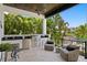 Outdoor kitchen with stainless steel grill and canal views from the seating area at 5004 S The Riviera, Tampa, FL 33609