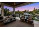 Covered outdoor living space offering comfortable seating, a view of the pool, and lush tropical landscaping at 5004 S The Riviera, Tampa, FL 33609