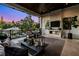 Charming outdoor living space featuring a fireplace, TV, comfortable seating, and beautiful landscape views at 5004 S The Riviera, Tampa, FL 33609