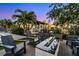 Beautiful outdoor seating area with a fire pit, lounge chairs, lush landscaping, and water views at 5004 S The Riviera, Tampa, FL 33609