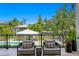 Comfortable outdoor chairs overlook the pool, canal, and manicured backyard at 5004 S The Riviera, Tampa, FL 33609