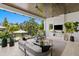 Cozy covered patio with a modern fireplace, outdoor seating, and a view of the backyard at 5004 S The Riviera, Tampa, FL 33609