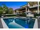 Luxurious backyard featuring a modern pool with lounge chairs, perfect for relaxation and enjoying outdoor living at 5004 S The Riviera, Tampa, FL 33609
