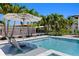 Beautiful pool with in-pool loungers and a clear view of the serene waterfront and lush tropical surroundings at 5004 S The Riviera, Tampa, FL 33609
