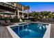 Inviting swimming pool with lounge chairs, umbrellas, and a stunning view of the grand home at 5004 S The Riviera, Tampa, FL 33609