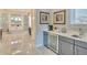 A luxurious wet bar, with a mini-fridge and sink, that is adjacent to the main bathroom at 5004 S The Riviera, Tampa, FL 33609