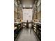 Custom wine cellar with wooden racks, ladder, and display area for an elegant wine storage solution at 5004 S The Riviera, Tampa, FL 33609