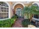 Beautiful front entryway with brick walkway, green doors, and lush landscape at 5125 Magnolia Pond Dr, Sarasota, FL 34233