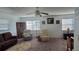 Bright and spacious living area with comfortable seating, natural light, and a ceiling fan at 5925 Terrace Park N Dr # 111, St Petersburg, FL 33709