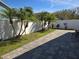 Paver patio area with lush landscaping and privacy fence creating a secluded backyard space at 6601 Thackston Dr, Riverview, FL 33578