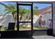 View of the landscaped backyard from the screened-in porch with exterior access at 6601 Thackston Dr, Riverview, FL 33578