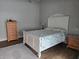 Charming bedroom with wood floors, white furniture, and a patterned bedspread creates a cozy atmosphere at 6601 Thackston Dr, Riverview, FL 33578
