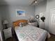 Comfortable bedroom with ceiling fan, bright window, and laminate flooring at 6601 Thackston Dr, Riverview, FL 33578