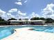 Stunning community pool with lounge chairs and clear blue skies at 6601 Thackston Dr, Riverview, FL 33578