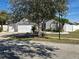 Charming single-story home with a three-car garage, well-manicured lawn, and inviting curb appeal at 6601 Thackston Dr, Riverview, FL 33578