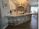 Modern kitchen with marble countertops, brick-accented island, and updated fixtures at 6601 Thackston Dr, Riverview, FL 33578