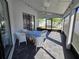 Relaxing screened-in patio featuring tiled floors, a ceiling fan, and outdoor dining set at 6601 Thackston Dr, Riverview, FL 33578