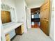 Well-lit dressing room boasts built-in vanity and seamlessly connects to a spacious living area at 7705 W Four Pines Rd, Plant City, FL 33565