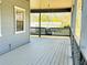 Inviting covered porch with swing, perfect for relaxing and enjoying the outdoors at 7705 W Four Pines Rd, Plant City, FL 33565