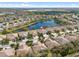 Aerial view of a neighborhood featuring well-maintained homes and a serene lake at 11565 Captiva Kay Dr, Riverview, FL 33569