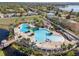 Aerial view of the community pool and amenities, surrounded by palm trees, offering a resort-like experience at 11565 Captiva Kay Dr, Riverview, FL 33569