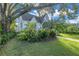 Charming home with lush landscaping and a mature shade tree at 156 21St Ne Ave, St Petersburg, FL 33704