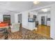 Open-concept living room with white walls and a unique tile floor leading into the kitchen at 156 21St Ne Ave, St Petersburg, FL 33704