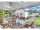 This screened porch features a table and seating for six at 156 21St Ne Ave, St Petersburg, FL 33704