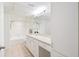 Clean bathroom featuring a shower-tub combo, white cabinets, and a vanity with ample storage at 1910 E Palm Ave # 10301, Tampa, FL 33605