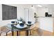 Contemporary dining area with glass table and chairs, adjacent to the kitchen at 1910 E Palm Ave # 10301, Tampa, FL 33605